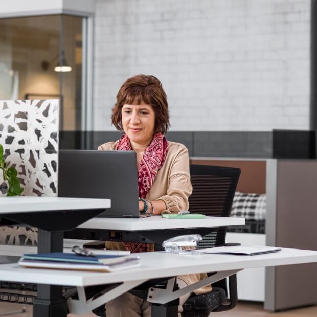Accountant sitting at her desk, setting up her business with QuickBooks